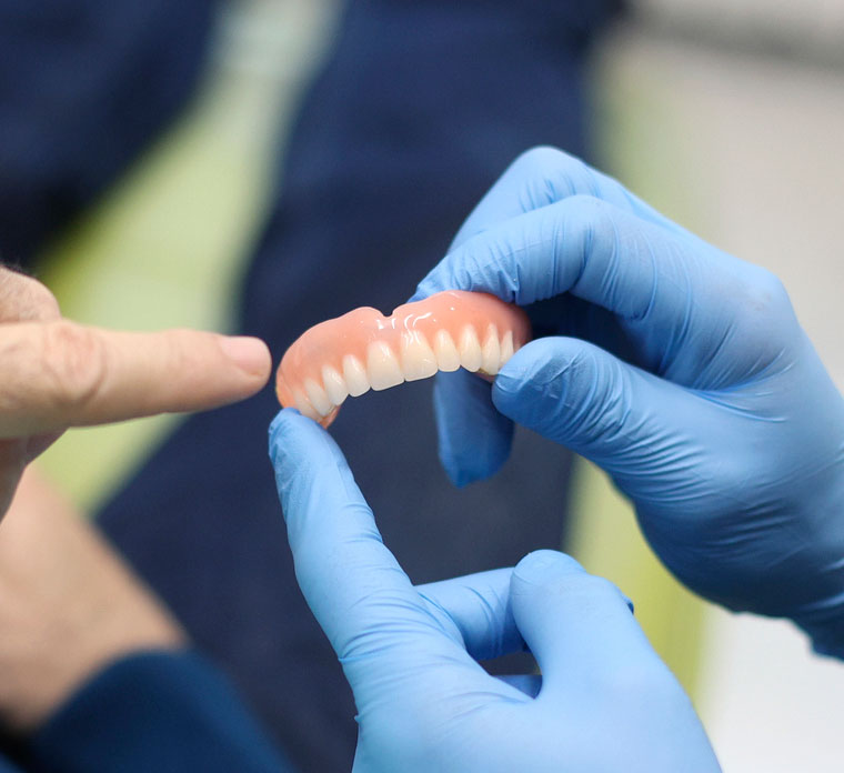Denture in hands